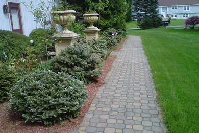 Inspiration for a mid-sized transitional shade side yard stone landscaping in Boston for summer.