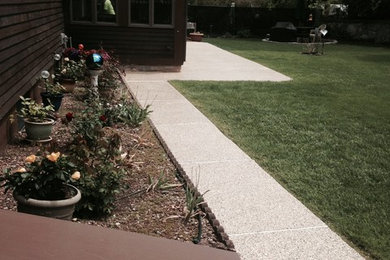 This is an example of a mid-sized traditional partial sun and drought-tolerant backyard concrete paver garden path in Philadelphia for spring.