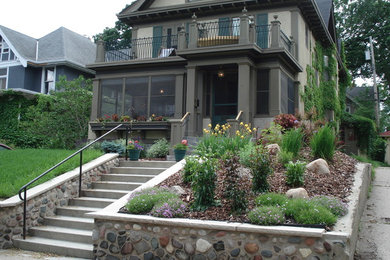 Inspiration for a mid-sized craftsman full sun front yard concrete paver retaining wall landscape in Minneapolis.