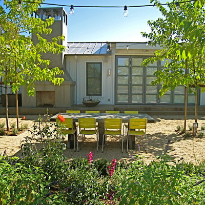 This is an example of a mid-sized farmhouse backyard gravel landscaping in San Francisco.