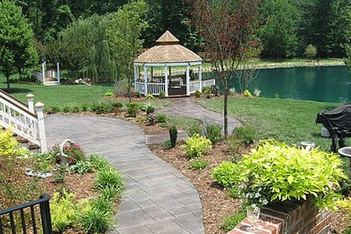 This is an example of a large classic back full sun garden in Louisville with concrete paving.