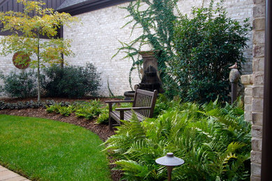 Design ideas for a traditional courtyard water fountain landscape in Raleigh.