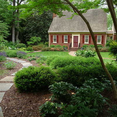 Photo of a large traditional front yard stone landscaping in Richmond.