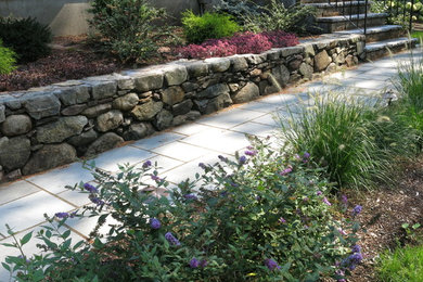 This is an example of a mid-sized transitional partial sun front yard stone garden path in Boston for spring.