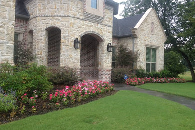 Design ideas for a large contemporary full sun backyard stone landscaping in Dallas for summer.