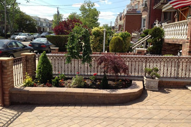 Inspiration for a small traditional full sun front yard concrete paver retaining wall landscape in New York for spring.