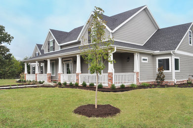 This is an example of a large farmhouse full sun front yard mulch driveway in Other for summer.