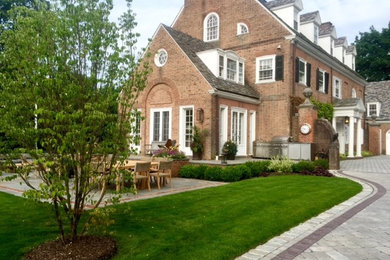 Design ideas for a small traditional full sun front yard concrete paver driveway in New York.