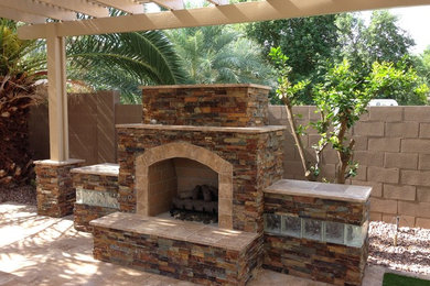 Patio - backyard stone patio idea in Phoenix with a fire pit