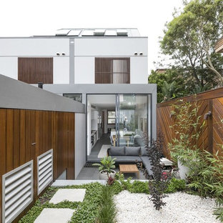 Inspiration for a contemporary backyard full sun garden in Other with a retaining wall and concrete pavers.