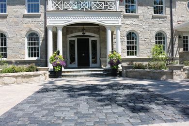 This is an example of a large contemporary partial sun front yard stone landscaping in Chicago.