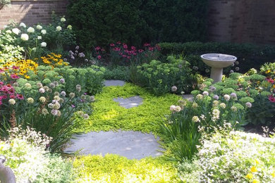 Design ideas for a large traditional partial sun backyard stone landscaping in Chicago.