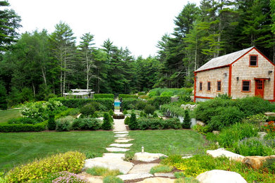 Inspiration for a traditional full sun backyard stone landscaping in Providence.
