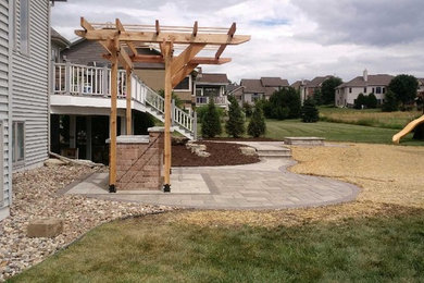 Photo of a mid-sized rustic full sun backyard concrete paver landscaping in Other with a fire pit for summer.