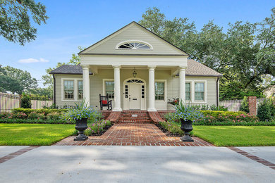 Inspiration for a mid-sized traditional partial sun front yard brick driveway in Other.