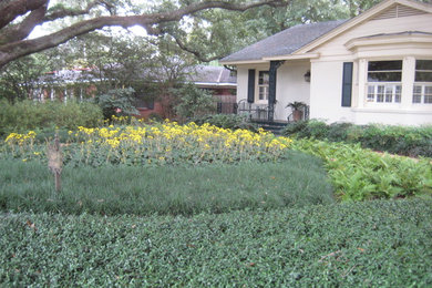 Inspiration for a large traditional partial sun front yard concrete paver formal garden in New Orleans.