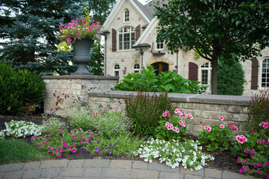 Inspiration for a large traditional partial sun front yard brick landscaping in Boston for summer.