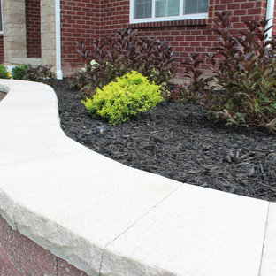 Design ideas for a large traditional full sun front yard brick landscaping in Detroit.