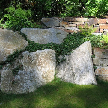 Granite boulders meet stone walls