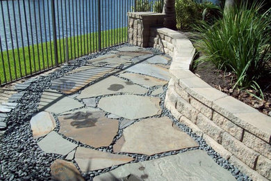 Design ideas for a large traditional full sun backyard stone garden path in Miami.