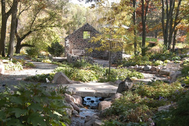 Inspiration for a large rustic shade backyard gravel landscaping in Other for spring.