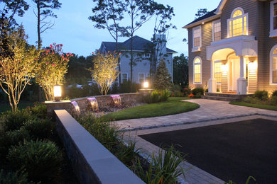 This is an example of a large coastal full sun front yard concrete paver driveway in New York.