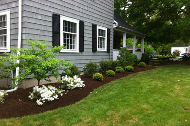 Design ideas for a mid-sized traditional full sun front yard landscaping in Providence with decking for summer.