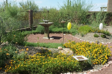 Photo of a mid-sized contemporary drought-tolerant and full sun backyard stone water fountain landscape in Phoenix.