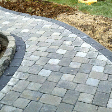 grey Concrete paver brick walkway with single border belgium block