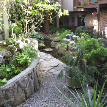 hand made rock wall for raised bed with koi pond