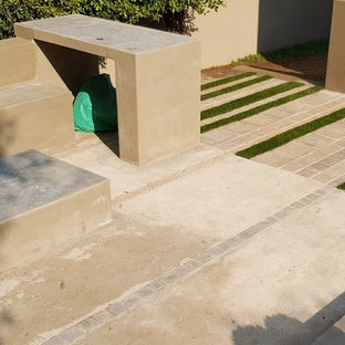 Mittelgroßer Stilmix Garten neben dem Haus mit Kamin, direkter Sonneneinstrahlung und Betonplatten in Sonstige