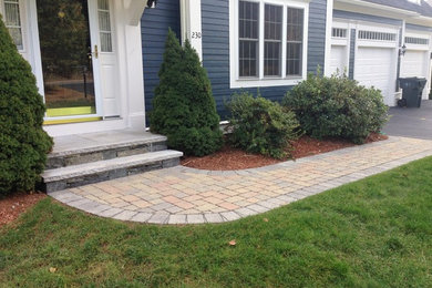 This is an example of a large traditional front yard concrete paver garden path in Boston.