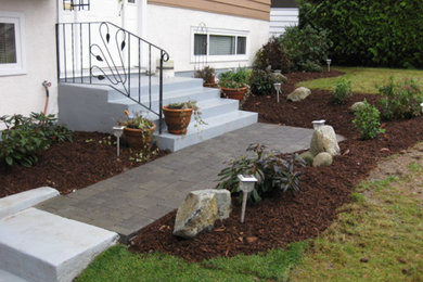 Diseño de jardín en patio trasero con adoquines de piedra natural