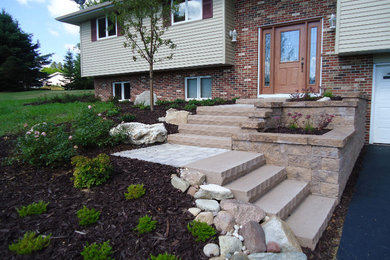 Inspiration for a mid-sized traditional full sun front yard concrete paver driveway in Other.