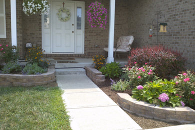 Inspiration for a medium sized front partial sun garden in Louisville with a garden path and concrete paving.