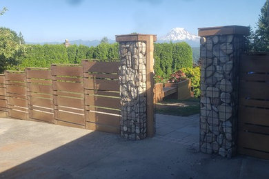 Photo of a large modern partial sun backyard brick landscaping in Seattle.