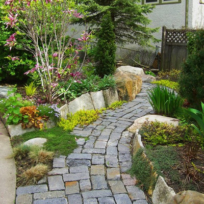 This is an example of a traditional full sun front yard stone garden path in Minneapolis.