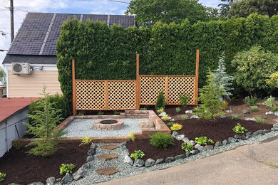 Design ideas for a mid-sized transitional full sun hillside mulch landscaping in Seattle with a fire pit.