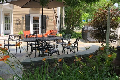 Inspiration for a large traditional side patio in DC Metro with natural stone paving.