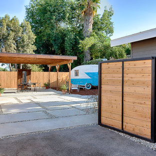 This is an example of a mid-sized craftsman full sun backyard concrete paver driveway in Other.