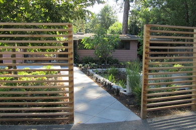 Inspiration for a mid-sized contemporary partial sun front yard concrete paver formal garden in Portland.