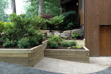 Design ideas for a rustic partial sun hillside retaining wall landscape in Other.