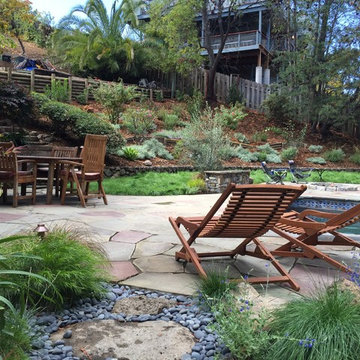 Hillside landscape patio, lawn and plantings
