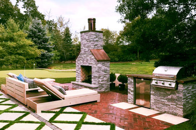 Inspiration for a small contemporary full sun backyard decomposed granite landscaping in Boston with a fireplace.