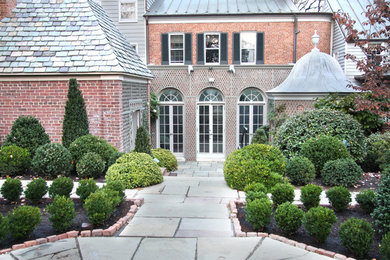 Photo of a mid-sized traditional backyard brick landscaping in DC Metro.