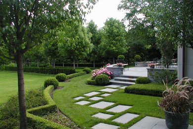 Large classic back partial sun garden for summer in Chicago with a garden path and natural stone paving.