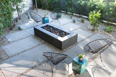 Design ideas for a small modern drought-tolerant and partial sun backyard concrete paver landscaping in Los Angeles with a fire pit.