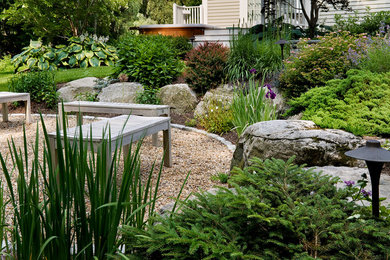 Inspiration for a traditional full sun backyard gravel landscaping in Portland Maine with a fire pit.