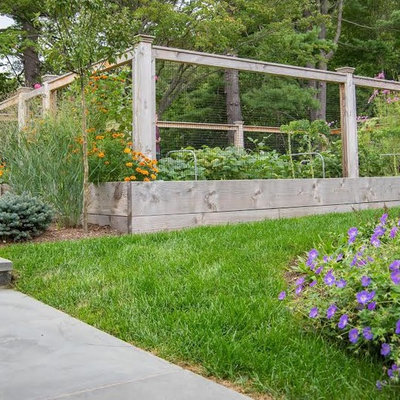Photo of a mid-sized rustic full sun backyard landscaping in New York for spring.