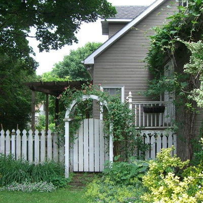 Design ideas for a large traditional shade backyard stone landscaping in Toronto for summer.